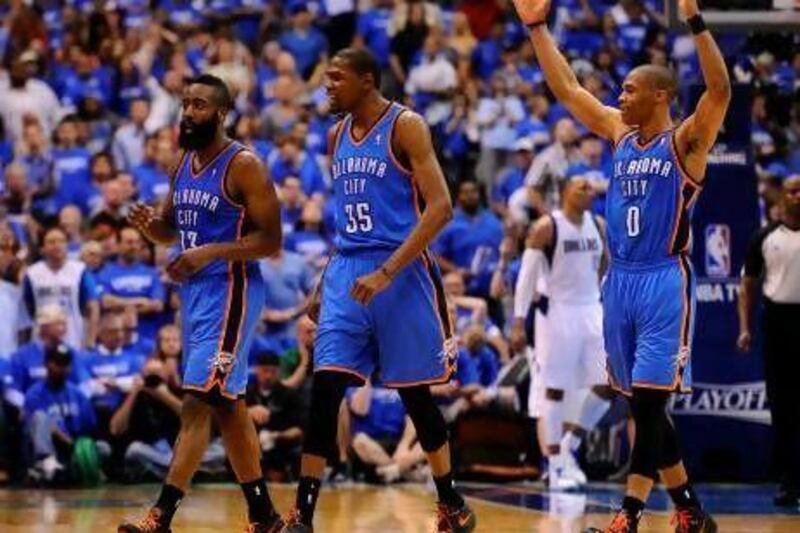 James Harden, left, Kevin Durant and Russell Westbrook, right, are ready to take a break after sweeping out the Dallas Mavericks in the first round of the NBA play-offs.