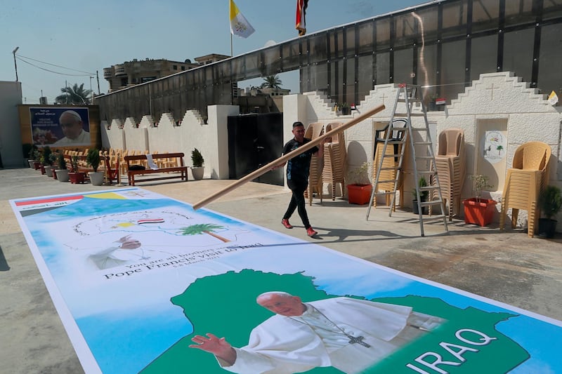 Posters welcoming Pope Francis are prepared at St. Joseph's Chaldean Church ahead of the Pope's visit, in Baghdad, Iraq. AP Photo