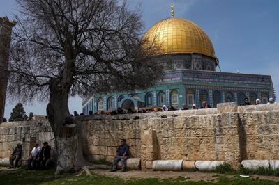 Muslim worshippers gather for Friday prayers next to the Dome of the Rock Mosque in the Al Aqsa Mosque compound in Jerusalem's old city.  AP Photo