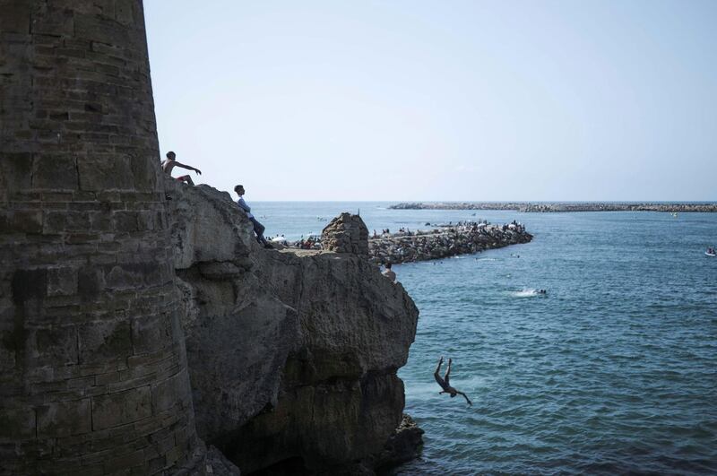 A boy jumps into the sea near the Kasbah of Udayas, a 12th century fortress famous for its white and blue streets, in Rabat, Morocco. AP