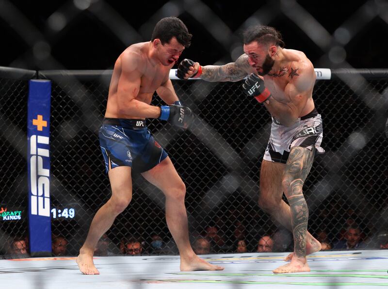 Shane Burgos (red gloves) competes against Billy Quarantillo (blue gloves) during UFC 268 at Madison Square Garden. Reuters