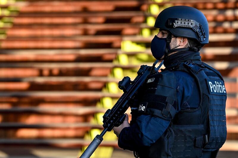 A heavily armed policeman stands guard outside the courthouse. AFP