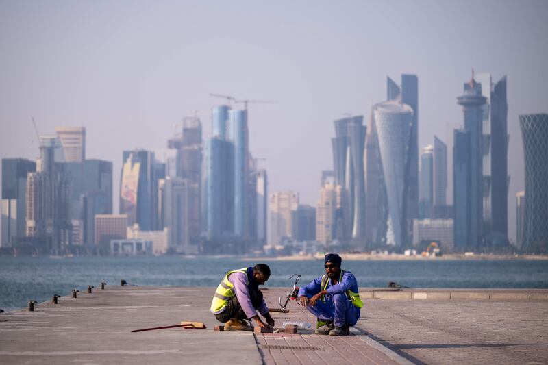Workers add finishing touches near the Fifa World Cup countdown clock in Doha.  AFP