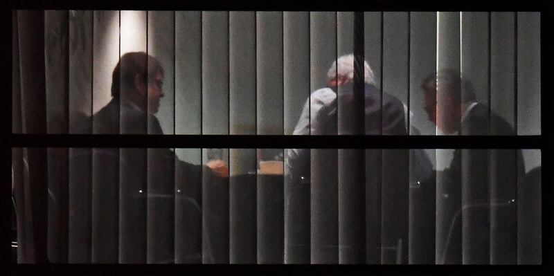 (L-R) Deputy-leader of the Social Democratic Party (SPD), Ralf Stegner, State Premier for the state of Hesse, CDU's Volker Bouffier and German Interior Minister Thomas de Maiziere asre seen through a window during talks between the leaders of the conservative CDU/CSU union and the SPD on forming a new government on January 11, 2018 at the SPD headquarters in Berlin.
Europe's most populous country and top economy has been in political stalemate since veteran centre-right leader Merkel won a September 24 election without a governing majority. / AFP PHOTO / Tobias SCHWARZ