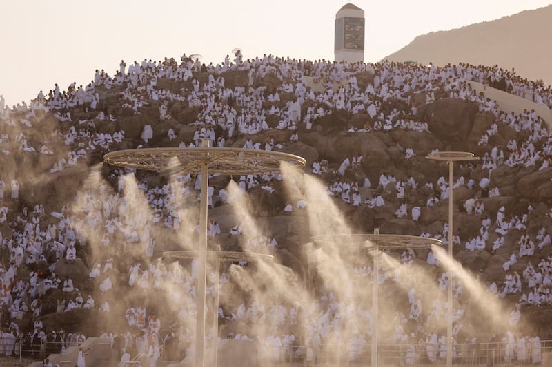Water mist is sprayed to help pilgrims keep cool as temperatures on Mount Arafat reach extreme highs. Reuters