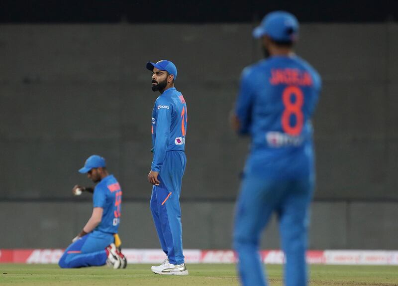 India's captain Virat Kohli, center, watches teammate Washington Sundar, left, drop a catch off Lendl Simmons. AP