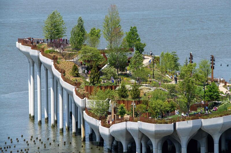 TOPSHOT - View of 'Little Island', a new, free public park in Hudson River Park on May 21, 2021 in New York City. On 132 huge concrete tulips installed on pillars on the banks of the Hudson River levitates "Little Island", a new floating public park of 260 million dollars inaugurated this sunny Friday in New York to the delight of the population, after more than one year of pandemic. / AFP / Angela Weiss

