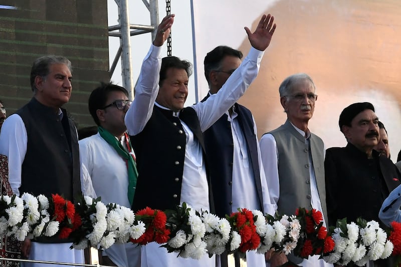 Pakistan’s Prime Minister Imran Khan, centre, waves to supporters of the country's ruling Tehreek-e-Insaf party at a rally in Islamabad. AFP