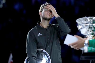 epa08187762 Dominic Thiem of Austria reacts as he listens to Novak Djokovic of Serbia deliver a speech after being defeated inhis men's singles final match at the Australian Open Grand Slam tennis tournament in Melbourne, Australia, 02 February 2020. EPA/FRANCIS MALASIG