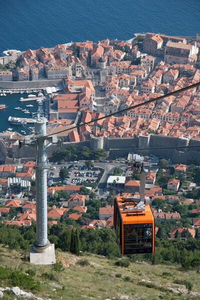 Dubrovnik, Croatia - June 14, 2013: View of the Old city and harbour of Dubrovnik and cable car from Mount Srdj. The cable car began transporting passengers in 1969. Getty Images