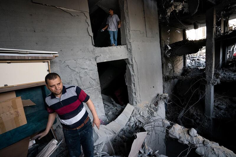 People enter the severely damaged Al Jawhara building to salvage valuable items following a ceasefire reached after an 11-day war between Gaza's Hamas rulers and Israel, in Gaza City. AP Photo