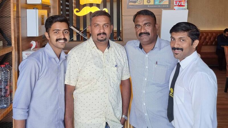 Sajesh Njattuketty, second from right, and Praveen Antony, second from left, will share Dh25 million prize money with 18 other colleagues.