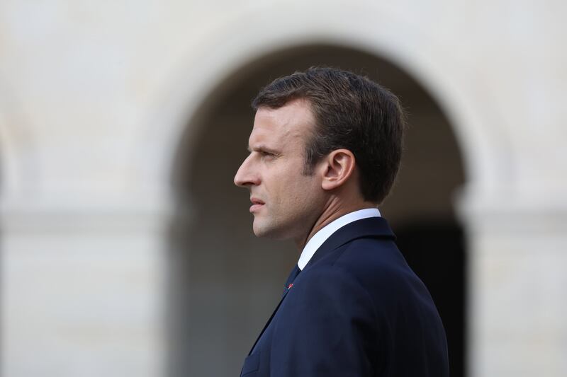 epa06220028 French President Emmanuel Macron looks on during a ceremony in tribute to late French WWII colonel Fred Moore at the Hotel des Invalides in Paris, France, 22 September 2017. Moore, a 'Companion of the Liberation', passed away in Paris the age of 97 on 16 September 2017.  EPA/LUDOVIC MARIN / POOL MAXPPP OUT