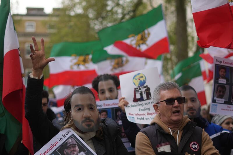 Demonstrators wear Salehi masks in London