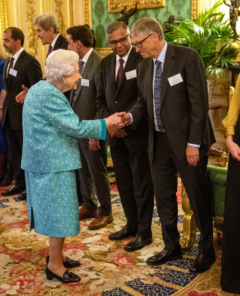 Queen Elizabeth greets Microsoft co-founder and philanthropist Bill Gates.