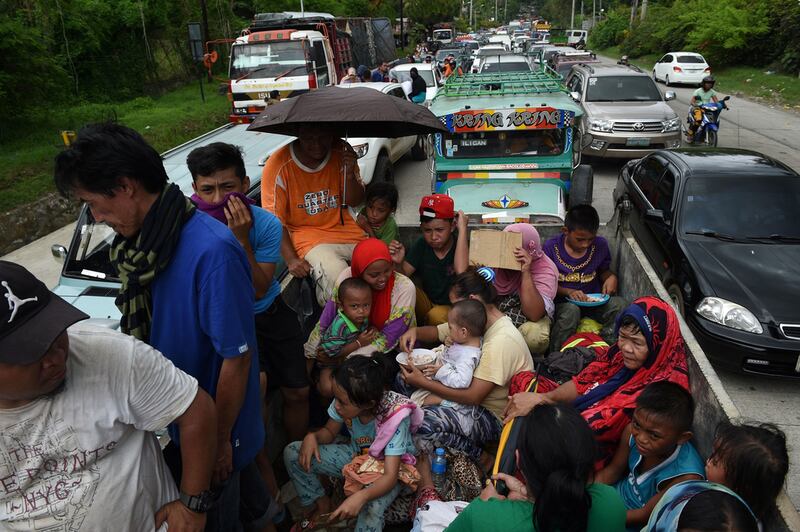 Resident flee from Marawi city where an ISIL-inspired group of gunmen rampaged through the city in Mindanao. Ted Aljibe / AFP Photo