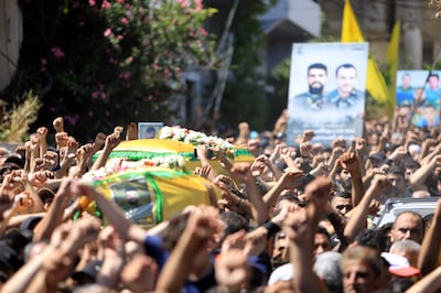 Mourners carry the coffins of two Hezbollah fighters in the southern Lebanese village of Aita Al-Shaab, near the border with Israel on Saturday. AFP