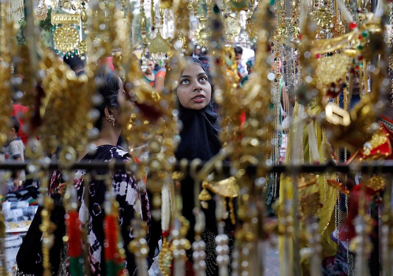 Women buy artificial jewellery and decorative items at a market ahead of Diwali, the Hindu festival of lights, in Ahmedabad, India, October 18, 2019. Reuters