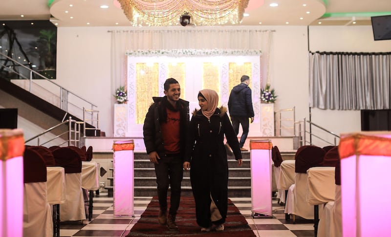 Palestinian groom Ahmed al-ketnani, 27, and his fiancee Sara, 19, stand at the wedding hall where their marriage ceremony was due to take place, after they have decided to postpone it amids a coronavirus pandemic in Gaza City.  AFP