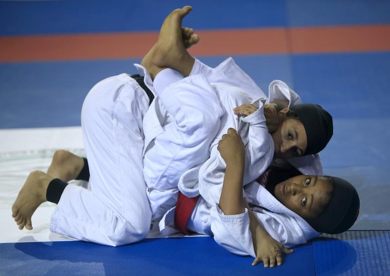 ABU DHABI - UNITED ARAB EMIRATES - 06NOV2015 - Shama al Naajmi (red belt) fights with Fatima Ali Saeed in the Martyrs Championships for juniors Jiu Jitsu yesterday at IPIC Arena at Zayed Sports City in Abu Dhabi. Ravindranath K / The National (to go with Amit story for Sports)