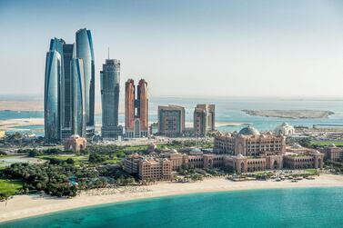 Abu Dhabi Hotels Record Strong Double-Digit Rise in Revenues in Q1 of 2019. Courtesy DCT Abu Dhabi Helicopter point of view of sea and skyscrapers in Corniche bay in Abu Dhabi, UAE. Turquoise water and blue sky combined with building exterior.