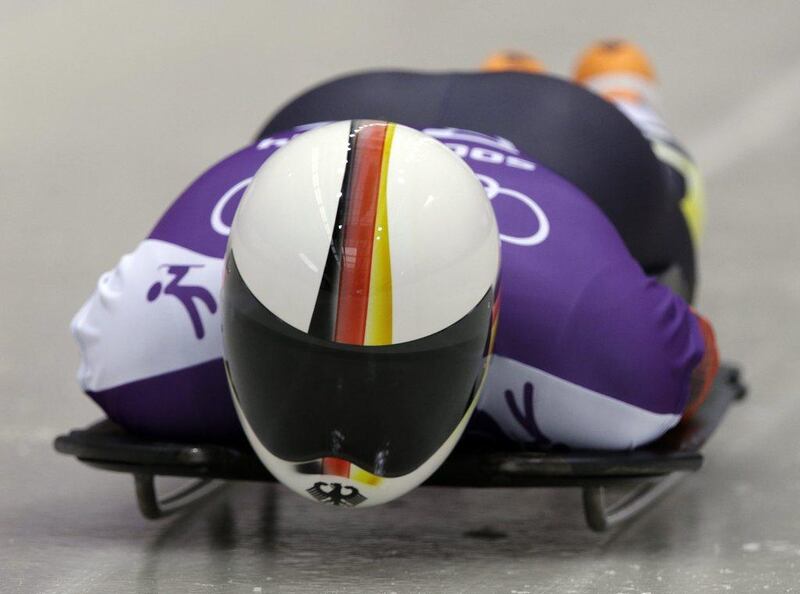 The sleek stripes on German Alexander Kroeckel's helmet are inspired by the German flag. Dita Alangkara / AP