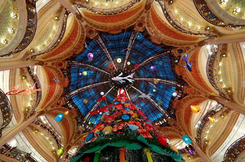 A giant Christmas tree stands at the Galeries Lafayette department store where lights were switched on for the festive season in Paris, France. Reuters