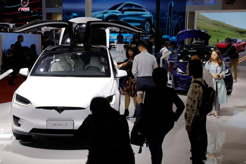 epa07509598 Visitors inspect a Tesla model X during the media day of the Auto Shanghai 2019 motor show in Shanghai, China, 16 April 2019. The 18th Shanghai international automobile industry exhibition runs from 16 to 25 April.  EPA/WU HONG