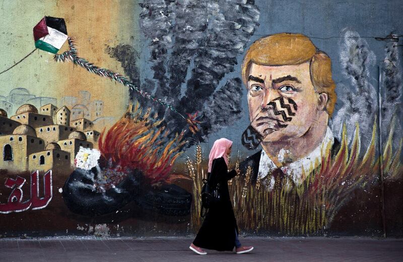 A wall with graffiti depicts US President Donald Trump with a footprint on his face in Gaza City.  AP