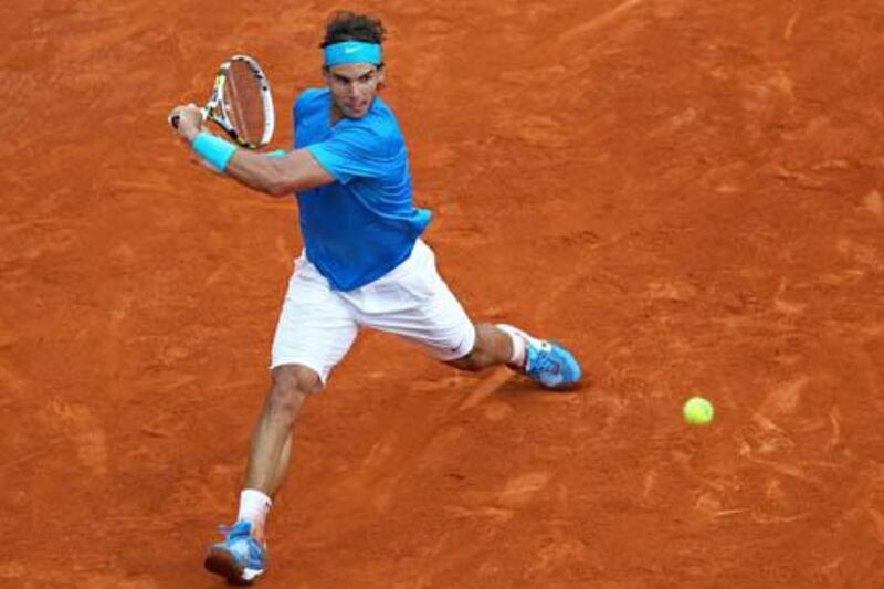PARIS, FRANCE - JUNE 05:  Rafael Nadal of Spain hits a backhand during the menâ€™s singles final match between Rafael Nadal of Spain and Roger Federer of Switzerland on day fifteen of the French Open at Roland Garros on June 5, 2011 in Paris, France.  (Photo by Clive Brunskill/Getty Images)