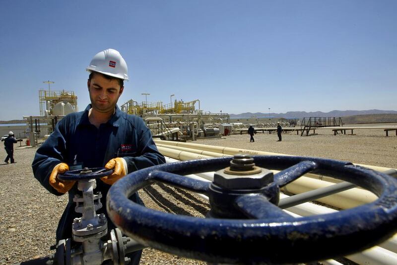 Above, a worker at the Tawke oilfield in Iraq’s Kurdish region. Ali Al Saadi / AFP
