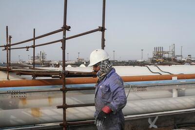 An Iranian man works at an oil facility in the Khark Island, on the shore of the Gulf, on February 23, 2016. - Iran's Oil Minister Bijan Namdar Zanganeh dismissed an output freeze deal between the world's top two producers Saudi Arabia and Russia as "a joke", the ISNA news agency reported. (Photo by STR / AFP)