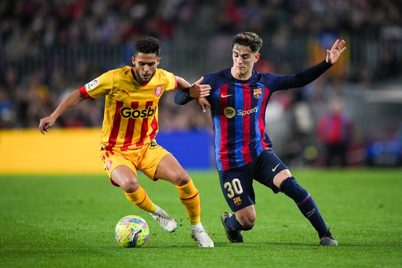 Yan Couto of Girona competes for the ball with Gavi of Barcelona. Getty Images