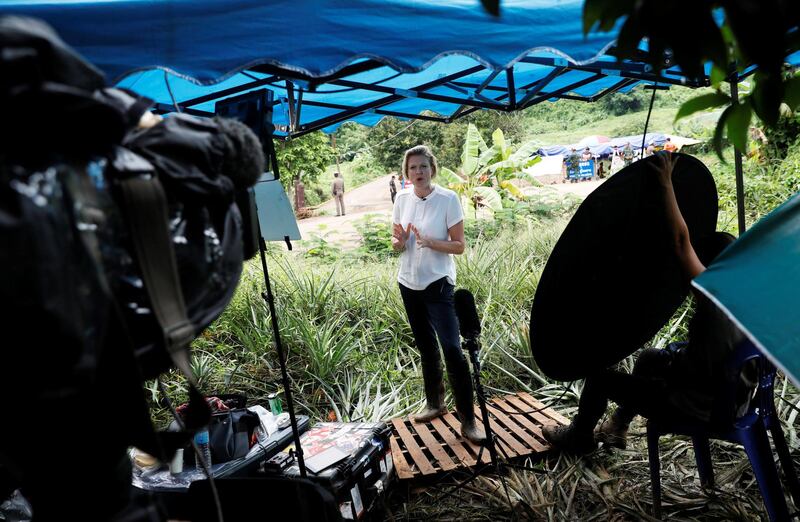 A journalist reports near the Tham Luang cave complex. Reuters