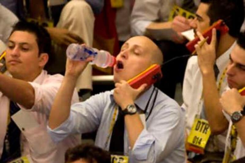 A trader drinks water as he works on the floor of the Brazilian Mercantile and Futures Exchange, in Sao Paulo, Wednesday, Oct. 1, 2008. Brazilian stocks are falling on investor uncertainty over whether U.S. lawmakers will manage to stitch together a bailout plan to save financial institutions and prevent a global slowdown. Sao Paulo's Ibovepsa index opened down 1.2 percent to 48,926 Wednesday ahead of a U.S. Senate vote on the rescue plan. But Brazil's currency, the real, opened slightly higher against the U.S. dollar. (AP Photo/Andre Penner) *** Local Caption ***  XAP102_Brazil_Markets.jpg