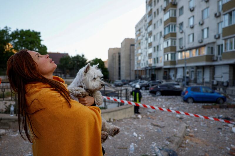 A woman assesses heavy damaged to an apartment building in Kyiv, after a massive drone strike by Russia. Reuters