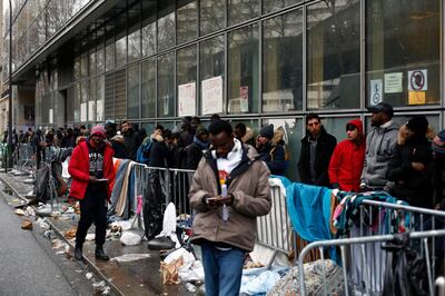 FILE - In this Dec.21, 2017 file photo, migrants queue outside a facility to apply for asylum, in Paris. French President Emmanuel Macron's government presents its first big immigration bill at Cabinet meeting Wednesday Feb.21, 2018. The government says the bill aims at accelerating expulsion of people who don't qualify for asylum and offering better conditions for those who are allowed to stay in the country. (AP Photo/Thibault Camus, File)