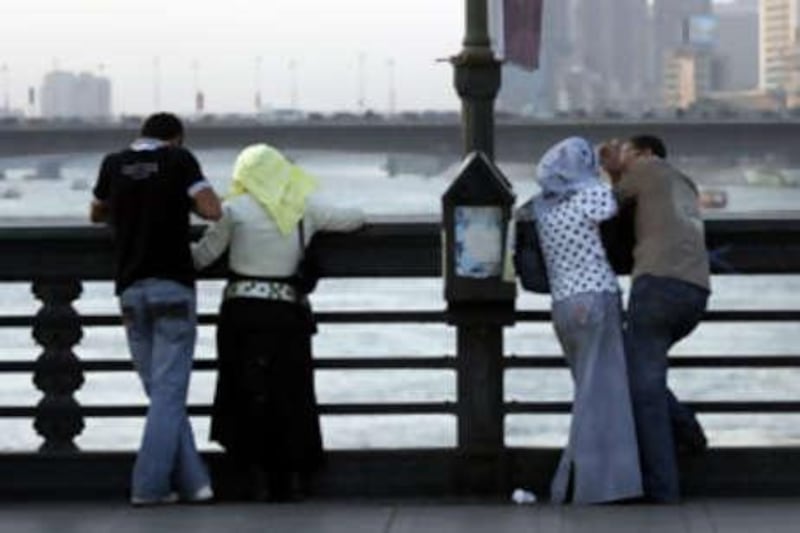 Couples meet on Qasr El Nil Bridge, one of Cairo's 'lovers' bridges', a free alternative to expensive dating venues in the city.