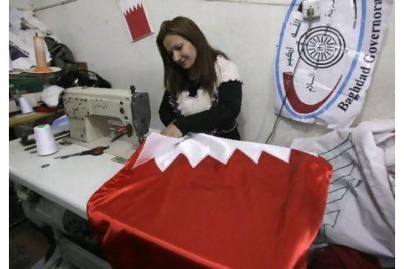 A woman works in a basement workshop in central Baghdad, Iraq, making a Bahrain national flag. The fervour for the Bahrain national symbol is testimony to the solidarity which Iraqi Shiites feel with their religious brethren.
