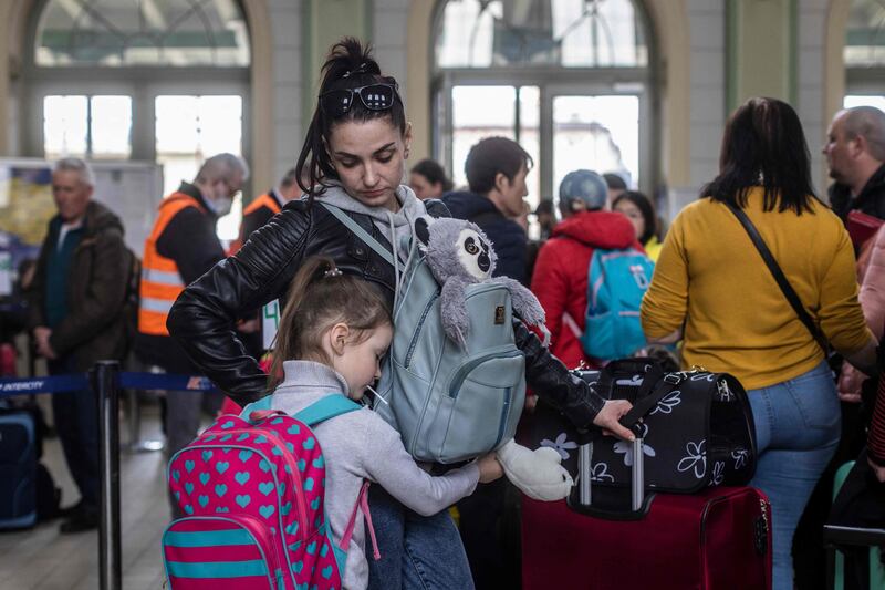 A woman and child in the ticket hall at the railway station in Przemysl, Poland, a gathering point for refugees from Ukraine. AFP