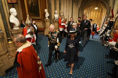 The Prince of Wales and Camilla walk through the Norman Porch in Britain's House of Lords for the annual opening of Parliament. PA