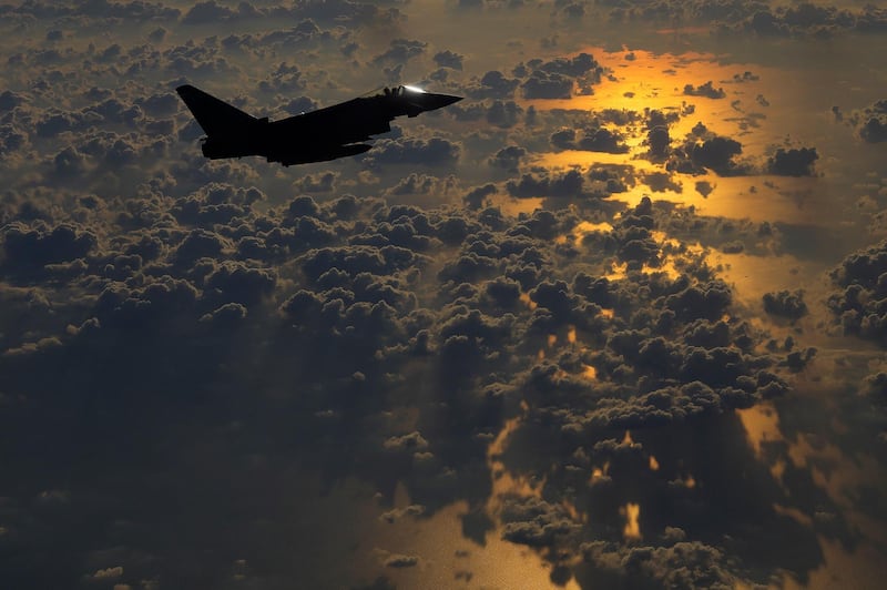A British RAF Typhoon aircraft escorts a C130 transport plane on its way to Jordan for an airdrop of paratroopers from the UK's 16th Air Assault Brigade. AP
