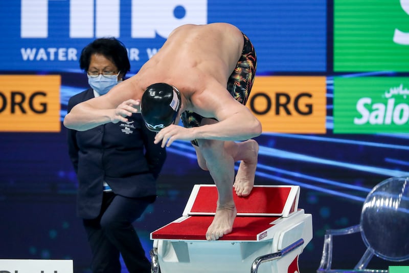 Swimmers warm up before the men's 50m butterfly event.