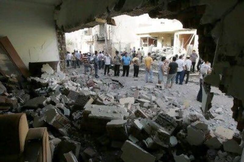 Residents gather at the site of a bomb attack in Kirkuk, 250km north of Baghdad.