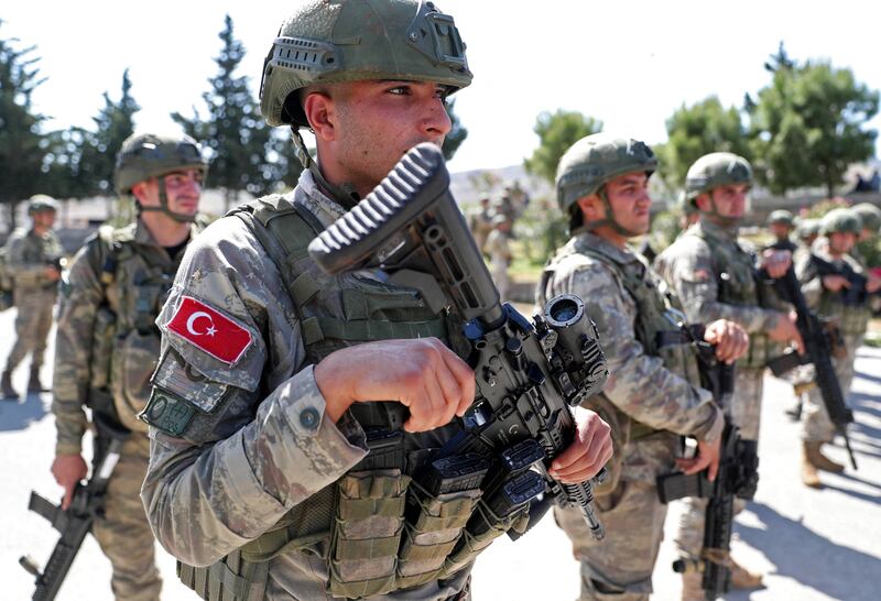 Turkish soldiers secure a section of the M4 motorway near Ariha in Idlib province.