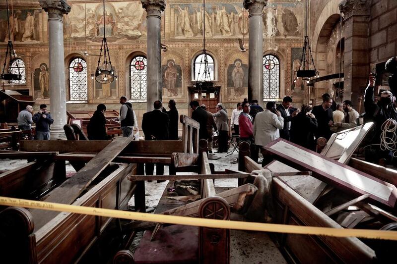 Security forces examine the scene inside the St. Mark Cathedral in central Cairo, Egypt, following a deadly bombing. Nariman El-Mofty / AP

