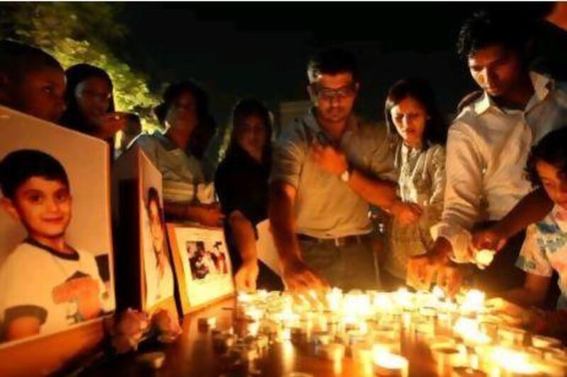 Mourners attend a vigil at St Mary's Catholic Church in Dubai for Nathan D'Souza, 5, and sister Chelsea, 7, who died after eating at a cafeteria in the emirate in 2009. Officials had ruled out food poisoning.