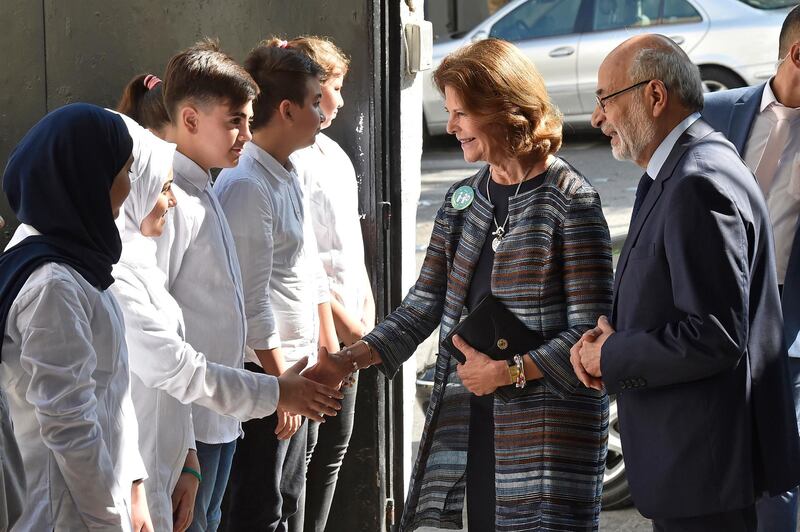Queen Silvia of Sweden shakes hands with a student of Rene Moawad Secondary school as she arrives with Lebanese Minister of Education Akram Chehayeb at a school in Beirut, Lebanon. EPA
