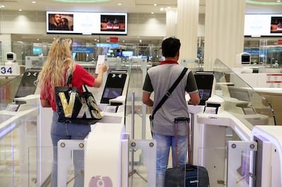 Dubai Airports recommend using Smart Gates to speed up the process at passport control. Pawan Singh / The National