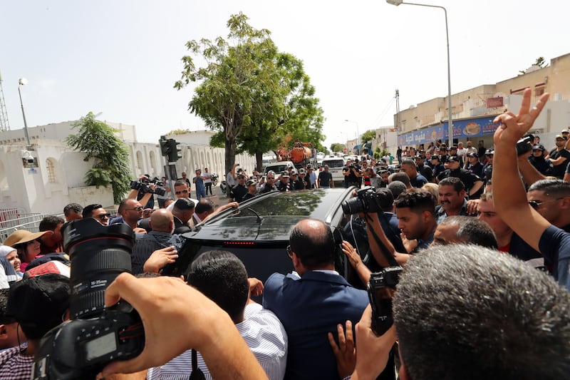 Rached Ghannouchi, head of Tunisia's Ennahda party, arrives by car for questioning in Tunis. His hearing was adjourned until Wednesday. EPA